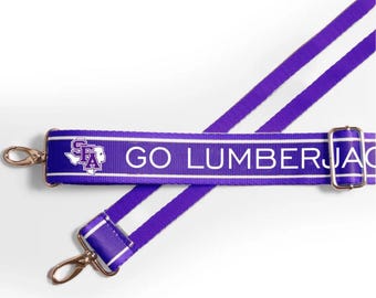 May include: Purple and white striped adjustable strap with the text "GO LUMBERJACKS" and a purple and white logo of a state outline with the letters "SFA".