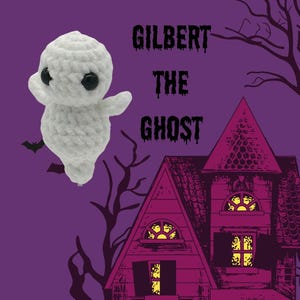 May include: A white crocheted ghost with black eyes, named Gilbert the Ghost, is flying in front of a purple background with a red and pink haunted house in the background.