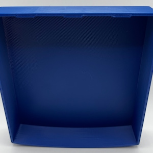 May include: A blue plastic storage box with a square shape and a smooth, textured surface. The box is empty and has a slightly curved bottom.