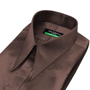 May include: A brown dress shirt with a wide collar. The shirt has a satin-like sheen and a tag that reads "John Clothes London Green Label."