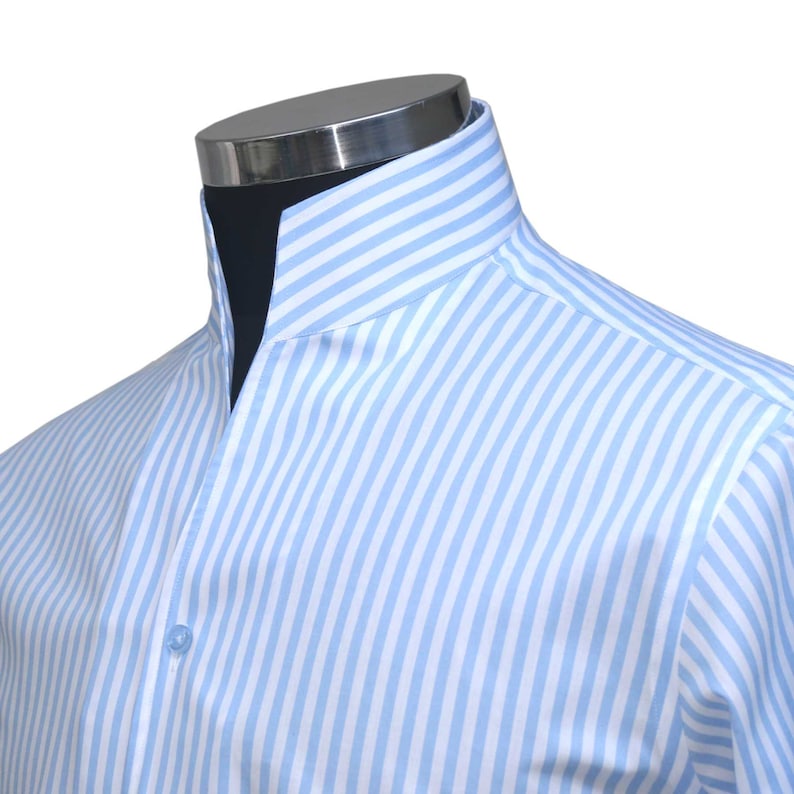 May include: A light blue striped dress shirt with a mandarin collar.