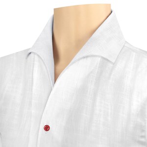 May include: A white linen shirt with a button-down collar and a single red button.