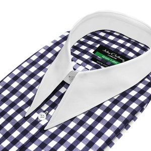 May include: A white collared dress shirt with a blue and white gingham pattern. The collar is a contrasting white color. The shirt has a label that reads "John Clothier London Green Label 100% Cotton".