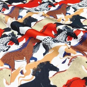 May include: Fabric with a repeating pattern of horses in various colors, including black, brown, red, and tan. The horses are depicted in a stylized, artistic manner, with some having patterned details. The background is white with some tan and red accents.
