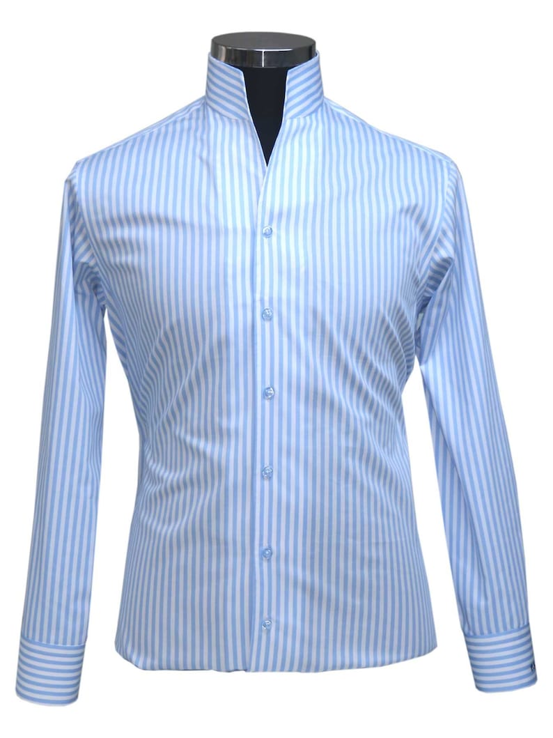May include: A light blue striped long-sleeve shirt with a mandarin collar and button closure.