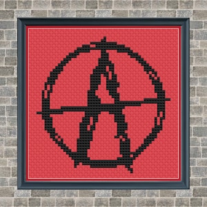 May include: A black and red cross-stitch pattern featuring a circle with a stylized anarchy symbol inside. The circle is outlined in black and the background is red.