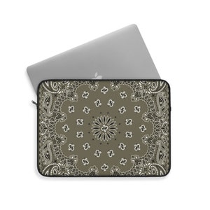 May include: A laptop sleeve with a brown paisley pattern. The sleeve has a zipper closure and is made of a durable material.