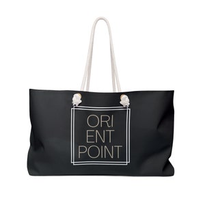 May include: Black canvas tote bag with white rope handles and a white graphic that says "ORIENT POINT" in a box.