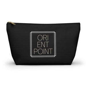 May include: Black canvas zippered pouch with a white double-lined rectangle containing the text "ORIENT POINT" in a beige font.