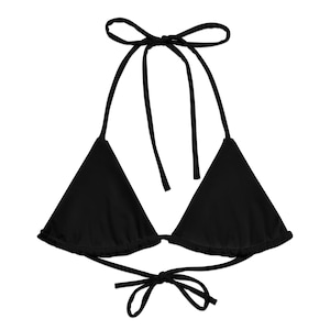 May include: A black triangle bikini top with halter neck ties and a tie closure at the back. The top is made of a solid black fabric and is designed for swimwear.