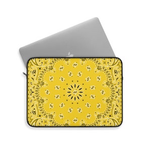 May include: Yellow laptop sleeve with a black and white paisley pattern.