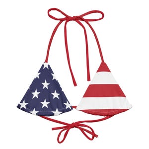 May include: A patriotic bikini top featuring the American flag design. One triangle displays a blue field with white stars, while the other has red and white stripes. The top has red ties at the neck and back.