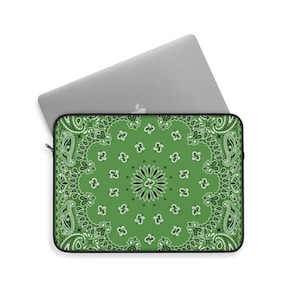 May include: Green laptop sleeve with a black and white paisley pattern. The sleeve has a zipper closure.