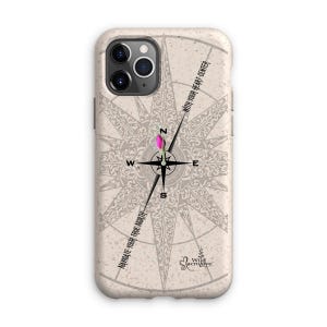 May include: A beige phone case with a compass design and the text "Navigate your true north" and "With your heart center".