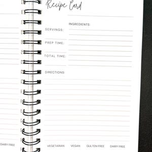 May include: A white spiral-bound recipe card notebook with black text. The page features fields for Recipe Card, Servings, Prep Time, Total Time, Ingredients, and Directions. Bottom labels include Vegetarian, Vegan, Gluten Free, and Dairy Free.