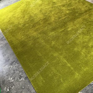 and-tufted solid green wool area rug with plush soft pile, modern minimalist design, perfect for living room, bedroom or contemporary interiors.
