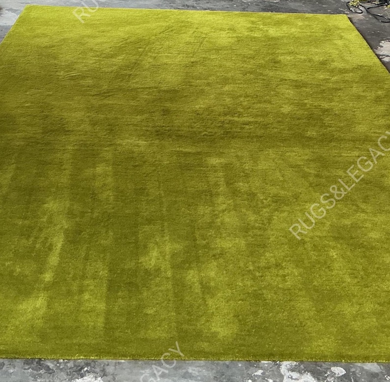and-tufted solid green wool area rug with plush soft pile, modern minimalist design, perfect for living room, bedroom or contemporary interiors.