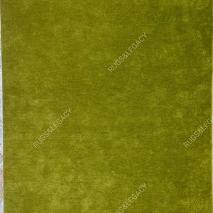 Modern solid green hand-tufted wool area rug photographed flat, showcasing clean edges and smooth finish