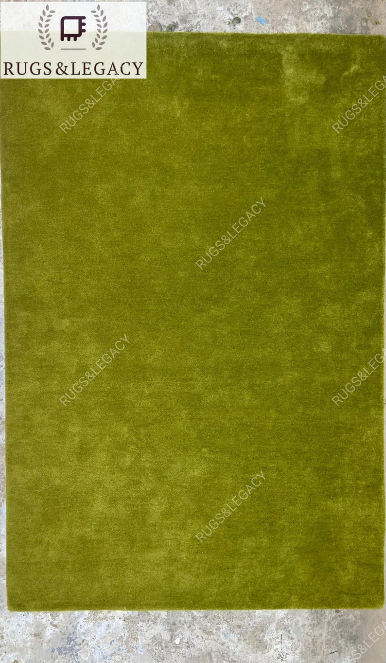 Modern solid green hand-tufted wool area rug photographed flat, showcasing clean edges and smooth finish