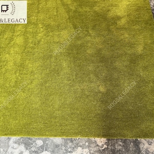and-tufted solid green wool area rug with plush soft pile, modern minimalist design, perfect for living room, bedroom or contemporary interiors.