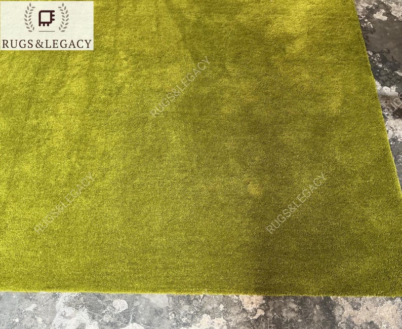 and-tufted solid green wool area rug with plush soft pile, modern minimalist design, perfect for living room, bedroom or contemporary interiors.