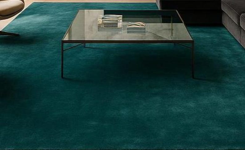 Close up texture shot of plush solid green wool rug for bedroom decor