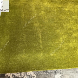and-tufted solid green wool area rug with plush soft pile, modern minimalist design, perfect for living room, bedroom or contemporary interiors.