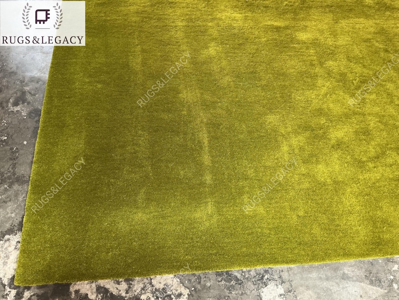and-tufted solid green wool area rug with plush soft pile, modern minimalist design, perfect for living room, bedroom or contemporary interiors.