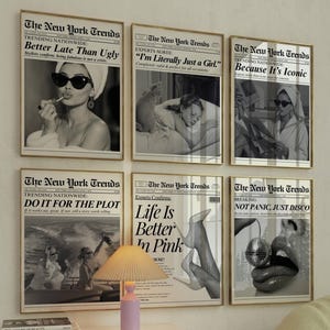 May include: Six framed black and white prints with gold frames. The prints feature images of women and text in a newspaper layout. The text includes phrases like "Better Late Than Ugly" and "Not Panic, Just Disco."