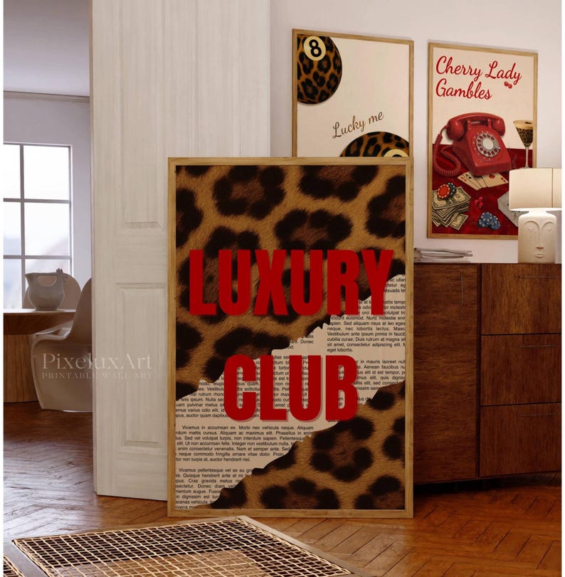 May include: Three framed wall art prints. The central print features a leopard print design with the words "LUXURY CLUB" in red. Two smaller prints show a leopard print 8-ball and a vintage phone with the text "Cherry Lady Gambles".