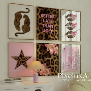 May include: A collection of framed wall art featuring leopard print, pink, and floral designs. One piece displays the text "Better Late Than Ugly." Other art includes leopard print lips with pink bows, a star, and a forest scene.