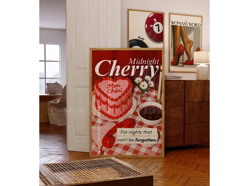 May include: A framed art print featuring a heart-shaped cake with the words "Midnight Cherry" and "Mon Ch&eacute;ri." The print also includes a red telephone and the text "For nights that can't be forgotten." Other framed prints are visible.