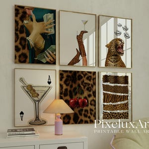 May include: A set of six framed wall art prints. The prints feature a variety of images, including a hand holding money, a martini glass, a leopard, and a pair of high heels. The color palette includes gold, brown, and white. The text "PixeluxArt PRINTABLE WALL ART" is visible.