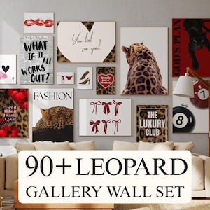 May include: A gallery wall set featuring various art prints with a leopard print theme. The collection includes prints with text like "What if it all works out?" and "The Luxury Club." Other prints feature lips, hearts, and bows. The set is displayed above a beige sofa.