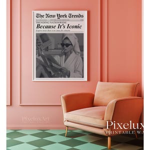 May include: A framed black and white print of a newspaper titled "The New York Trends" with the headline "Because It's Iconic." The print hangs on a pink wall above a peach-colored armchair. The floor has a green and white checkered pattern.