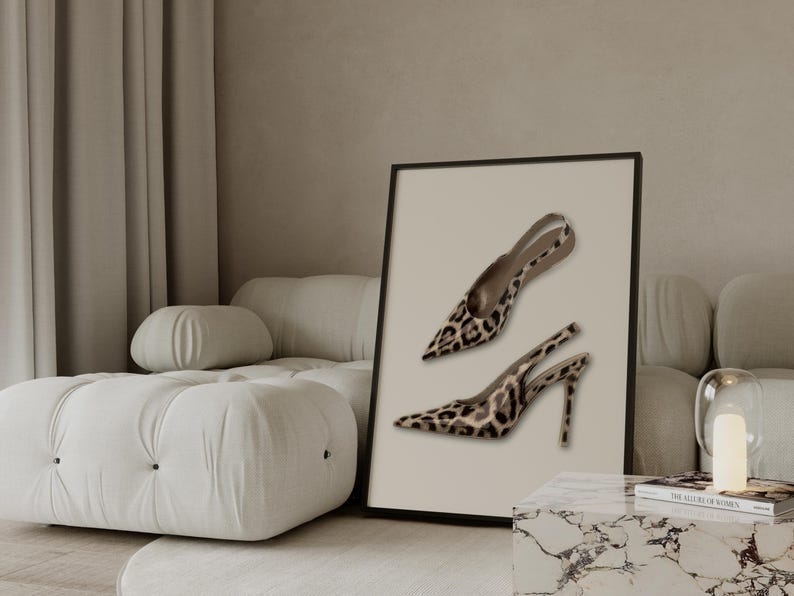 May include: A framed print featuring two high-heeled shoes with a leopard print design. The shoes have pointed toes and thin straps. The print is displayed on a neutral background, adding a touch of elegance to the decor.