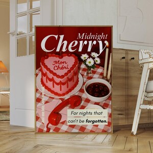 May include: A framed poster with a red background features the words "Midnight Cherry" and a heart-shaped cake with "Mon Ch&eacute;ri" written on it. A bowl of cherries, a red phone, and the text "For nights that can't be forgotten" are also visible.