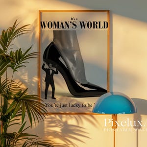 May include: Framed print with the text "It's a Woman's World" and a black high-heeled shoe. A small figure in a suit appears to be holding up the shoe. The text "You're just lucky to be" is also visible.