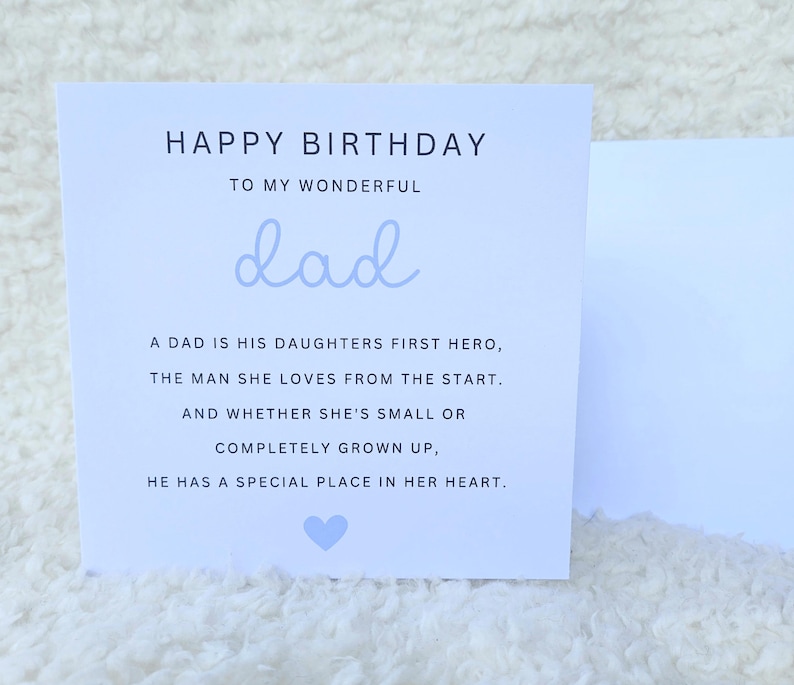 May include: A light blue card with the text "HAPPY BIRTHDAY TO MY WONDERFUL dad" and a poem about a dad being his daughter's first hero. The card has a small light blue heart at the bottom.