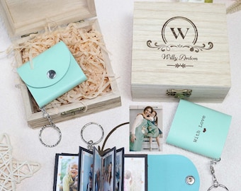 May include: A light blue leather photo album keychain with a small wooden box and a larger wooden box with the engraved text "W Willy Anton".