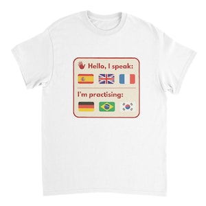 May include: White t-shirt featuring a graphic with the text "Hello, I speak:" and the flags of Spain, the UK, and France. Below, it reads "I'm practising:" with the flags of Germany, Brazil, and South Korea.