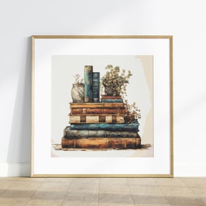 May include: A framed print featuring a stack of vintage books in shades of brown, blue, and orange. A small vase and a potted plant sit atop the books. The artwork has a pixelated, cross-stitch style.