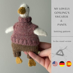 May include: A knitted goose doll wearing a pink sweater and brown trousers. The goose has white wings, a white head, and a yellow beak and feet. The image includes text that reads "MY LOVELY GOSLING'S SWEATER & PANTS knitting pattern".