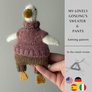 May include: A knitted white goose toy wearing a mauve turtleneck sweater and brown pants with yellow feet. The text reads: MY LOVELY GOSLING'S SWEATER & PANTS knitting pattern In-the-round version. Includes illustrations of knitting needles.
