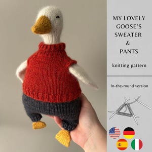 May include: A knitted goose toy with a white head, yellow beak, and yellow feet. The goose wears a red sweater and dark gray pants. Text reads: MY LOVELY GOOSE'S SWEATER & PANTS knitting pattern. In-the-round version. Includes a graphic of knitting needles.