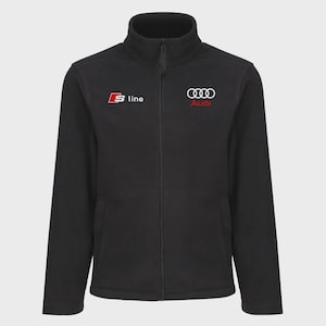 May include: Black fleece jacket with a full-length zip and a stand-up collar. The jacket displays the "S line" logo on the left chest and the Audi logo on the right chest, in red and white.