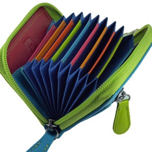 May include: Open, zippered wallet with a lime green exterior and a blue interior. The wallet is filled with colorful card slots in shades of orange, pink, and green. A teal blue leather pull tab is attached to the zipper.