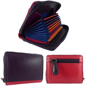 May include: A collection of leather wallets in various colors. One wallet is open, revealing multiple card slots in shades of blue, orange, and pink. The wallets are primarily purple and red, with black zippers and accents. The wallets are designed for carrying cards and cash.