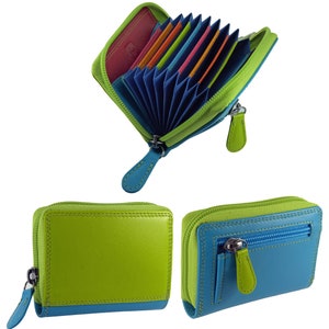 May include: A colorful leather wallet with a zip-around closure. The wallet features a vibrant combination of green, blue, and pink. Inside, multiple card slots are visible, showcasing a rainbow of colors. The wallet has a matching blue zipper pull.