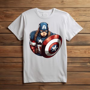 以下が含まれることがあります： キャプテン・アメリカのグラフィックが描かれた白いTシャツ。イラストは、キャプテン・アメリカが象徴的な青、赤、白のコスチュームを着て、盾を持っている様子を描いています。盾は、中央に白い星が付いた赤と白のストライプのデザインです。